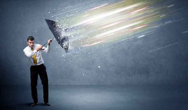 istock Business man defending light beams with umbrella concept 1066983482