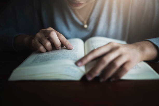 istock Young student reading Thai book at the public library. 1066985628