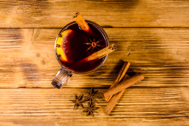 istock Cup of mulled wine with cinnamon on wooden table. Top view 1066985992