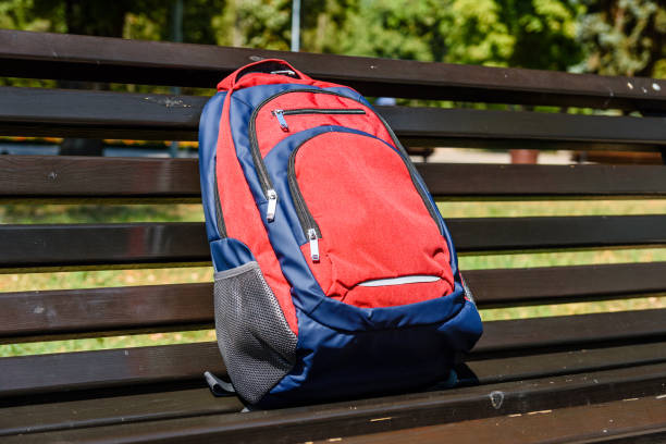 istock Tourist backpack on a bench in city park 1066986096