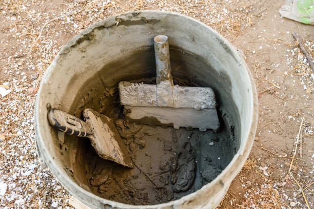 istock Two spatulas in bucket with the mortar 1066986098