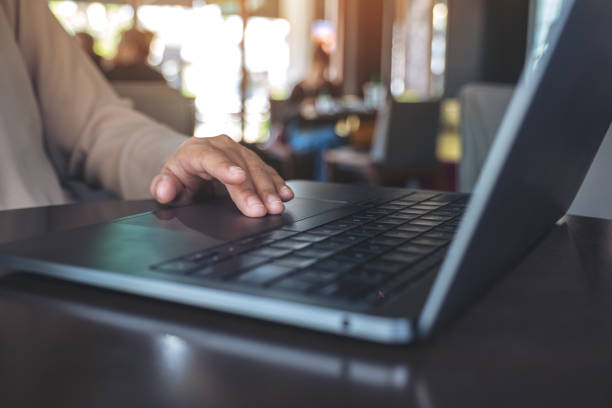 istock Closeup image of hands using and touching on laptop touchpad on wooden table 1066987008