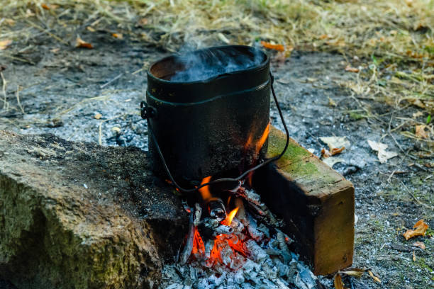 istock Cooking food in a kettle on bonfire 1066988150
