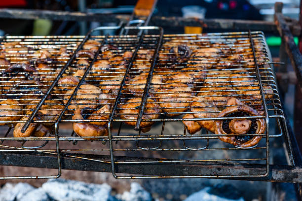 istock Champignons preparing in a barbecue grill on picnic 1066988190