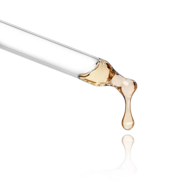istock Liquid drop from cosmetic pipette close up, isolated on white background 1066990496