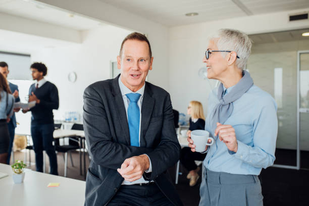 istock Mature coworkers drinking coffee 1066990778