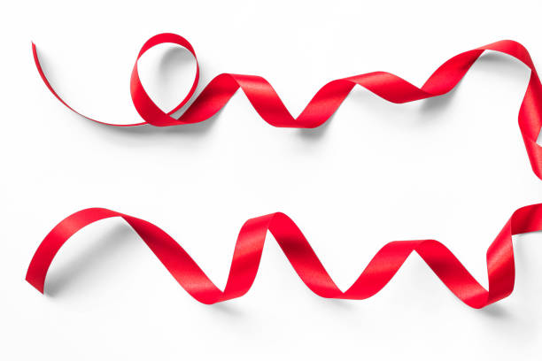 istock Red satin ribbon curly bow color isolated on white background with clipping path for Christmas holiday greeting card design decoration element 1066991872
