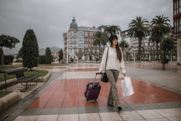 istock Young tourist carrying suitcase and bag 1066992050