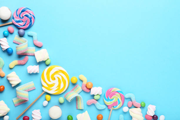 istock Sweet candies and lollipops on blue background 1066992162
