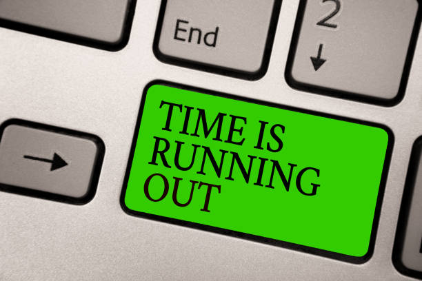 istock Writing note showing Time Is Running Out. Business photo showcasing Deadline is approaching Urgency things cannot wait Silver grey computer keyboard green button with black letters. 1066994628