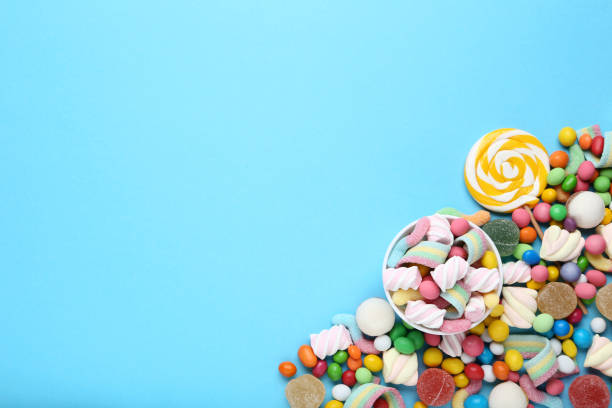 istock Sweet candies and lollipop on blue background 1066996156
