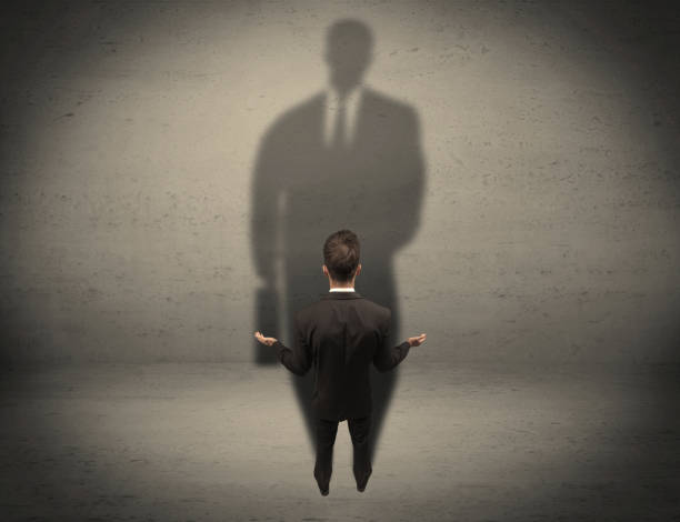 istock Businessman looking at big shadow concept 1066996836