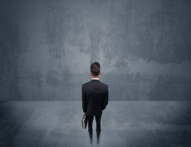 istock Businessman standing in front of urban wall 1066997112