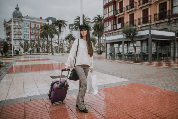 istock Young tourist carrying suitcase and bag 1066998700