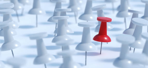 istock Difference concept. Red pushpin or thumbtack and many white ones. 3D rendered illustration. 1066999778