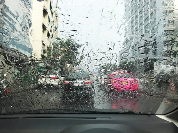 istock Road view through car window with rain drops, Driving in rain 1066999912