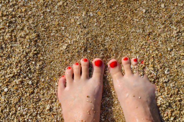 Feet on the sea in summer.