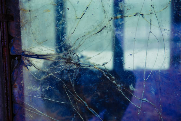 istock Old dirty cracked and broken window, Industrial background 1067000426