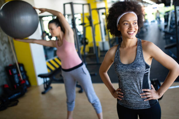 istock Group of young people doing exercises in gym 1067002088