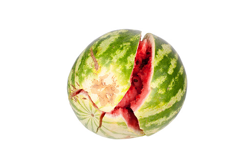 Broken watermelon on white mirror background with reflection isolated close up