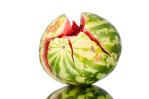 Chopped watermelon on white mirror background with reflection isolated close up
