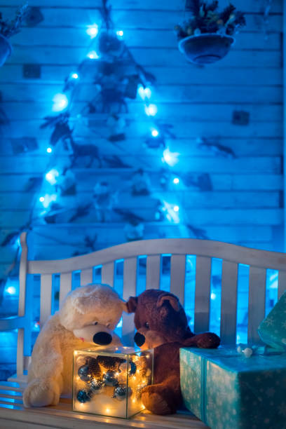 istock Teddy Bears with Christmas Ornaments and Gift on Bench. Rustic style 1067003564