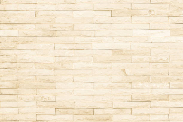 istock Seamless cream pattern of decorative brick sandstone wall surface with concrete of modern style design decorative uneven have cracked realmasonry wall of multicolored stones or blocks with cement. 1067004226