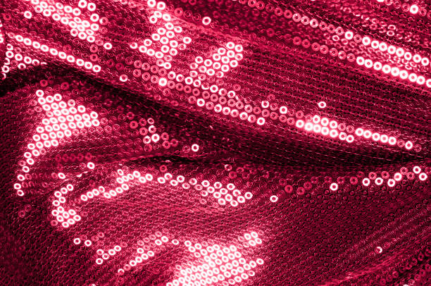 istock Background texture, pattern. Cloth red maroon with paillettes. Look at these Neon Pink Paillette Sequins. Round neon pink paillette sequins overlap with an iridescent sheen across a sheer purple mesh 1067006176