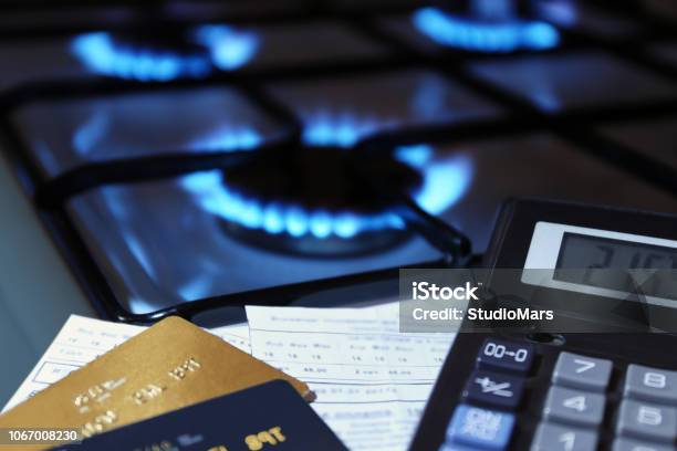 Bank Cards And A Calculator On The Background Of A Gas Stove Stock Photo - Download Image Now