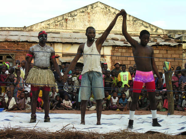 Pweto, Katanga, DRC, 20th May 2006: Wrestling match. Referee announcing winner. In a village  where there is no access to entertainment activities an itinerary circus makes a single show for the delightment of the devoted crowd