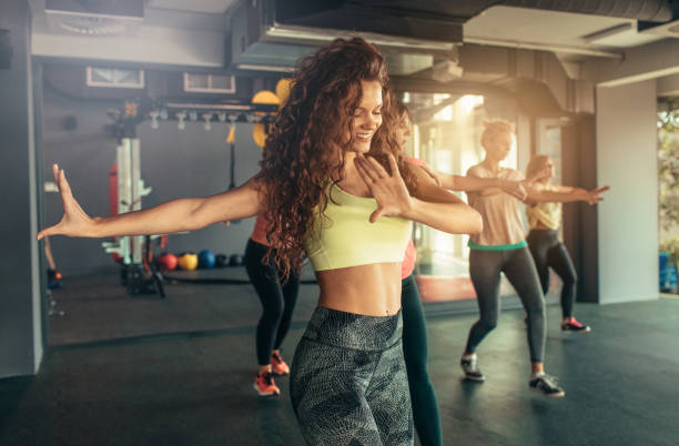 Dance Fitness Group of women enjoying dance fitness. danser stock pictures, royalty-free photos & images