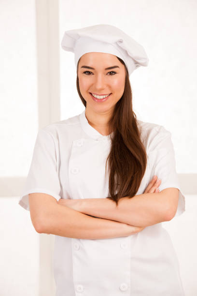 istock young blonde chef woamn holds kitchenware as she prepares to cook a meal isolated over white background 1067014976