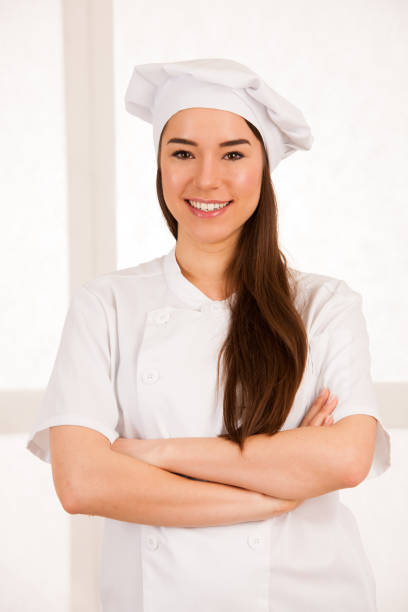 istock young blonde chef woamn holds kitchenware as she prepares to cook a meal isolated over white background 1067014992
