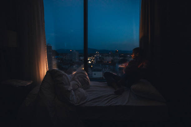 istock Sitting by the window at night 1067015278