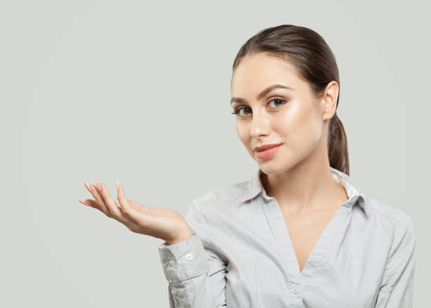 istock Young woman showing empty copy space on the open hand on white background. Product placement and advertising marketing concept 1067015688