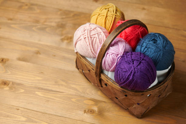 istock colorful wool threads for knitting on wooden background 1067015902