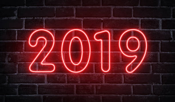 istock Neon glowing 2019 new year advertising design on wall 1067019830