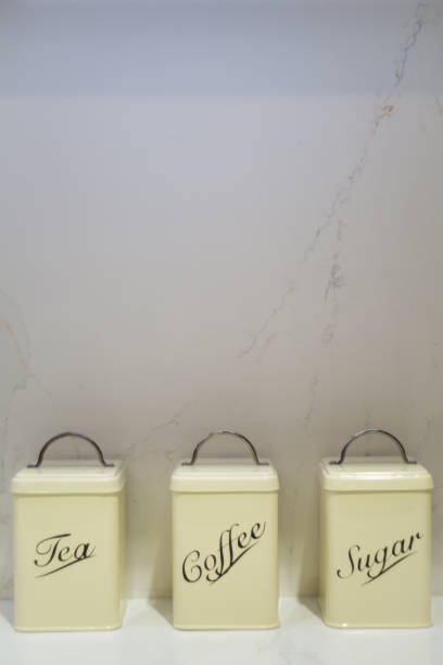 istock Tea, Coffee and Sugar tins on a marble worktop 1067021736