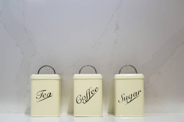 istock Tea, Coffee and Sugar tins on a marble worktop 1067021826