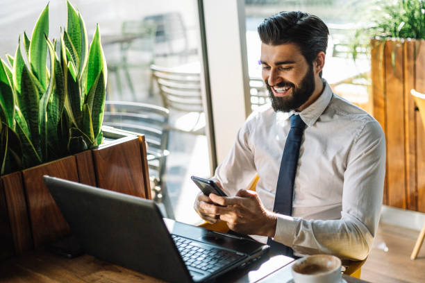 istock Attractive young businessman drinks coffee and using smart phone 1067024926