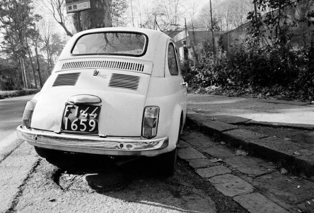 White outdoor model in the traffic. Fiat 500 last century vintage car. 1950 1960 1970 1980 1990 Florence Tuscany  Italy Europe
