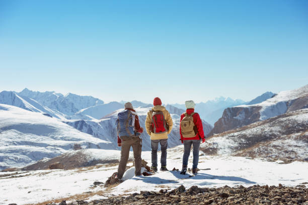istock Three tourists stands on mountain pass 1067029040