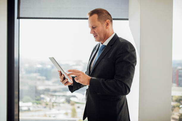 istock Older businessman looking at digital tablet 1067029272