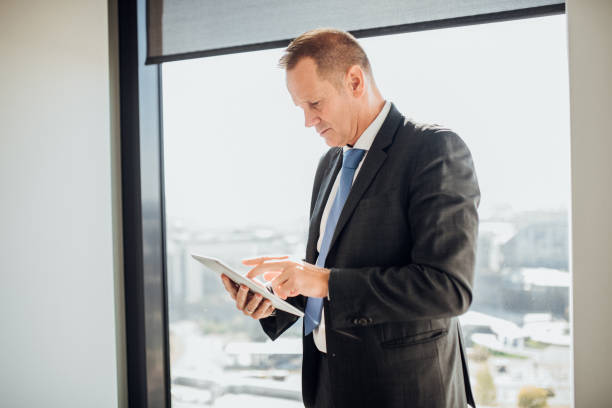 istock Serious businessman looking at digital tablet 1067029308