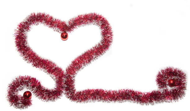 Heart of red Christmas tinsel with three red balls stock photo