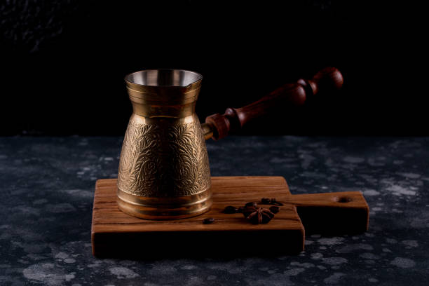 istock Turkish Coffee Pot and Coffee. Old coffee pot and roasted beans on dark background. 1067029956
