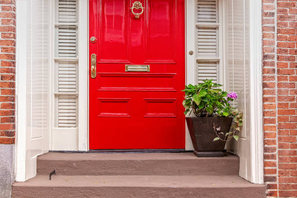 red door and potted plant on the steps residence front entrance doorstep stock pictures, royalty-free photos & images