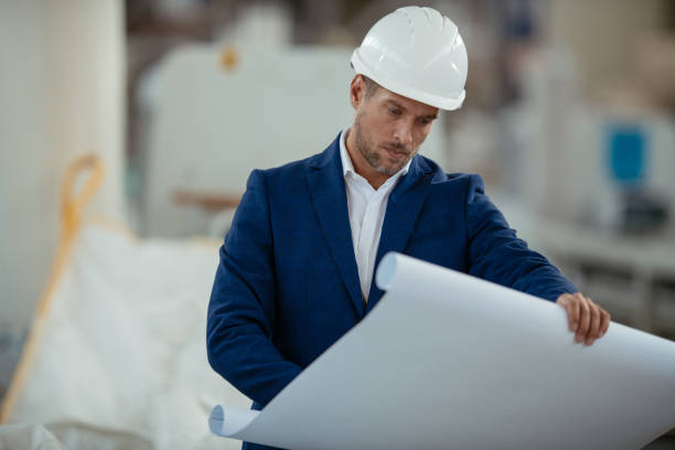 istock Engineer with blueprint in factory 1067037068