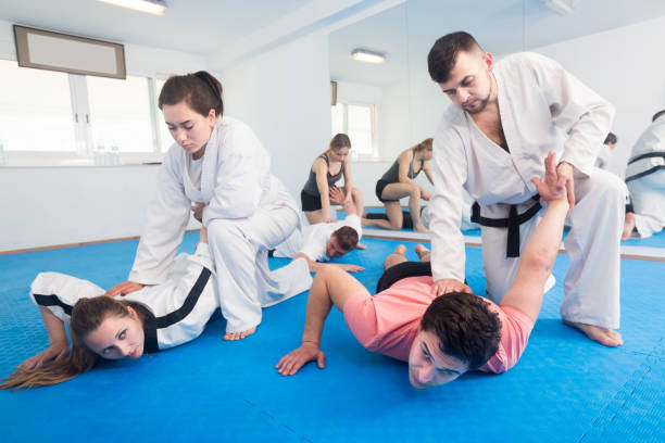 istock trainees sparring in pairs to practice new holds in taekwondo class 1067038048