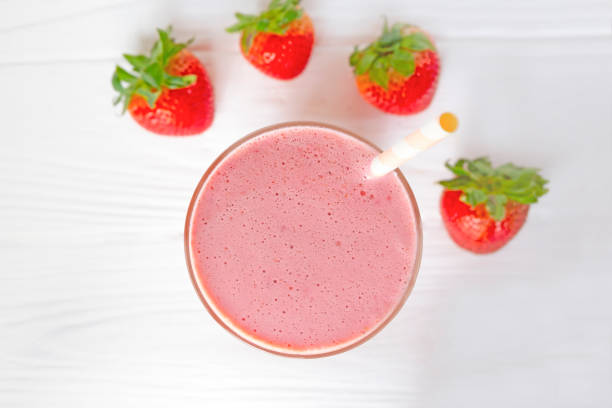 Strawberry smoothies yogurt  juice and strawberry  fruit for breakfast in the morning  on white wood from the top view.